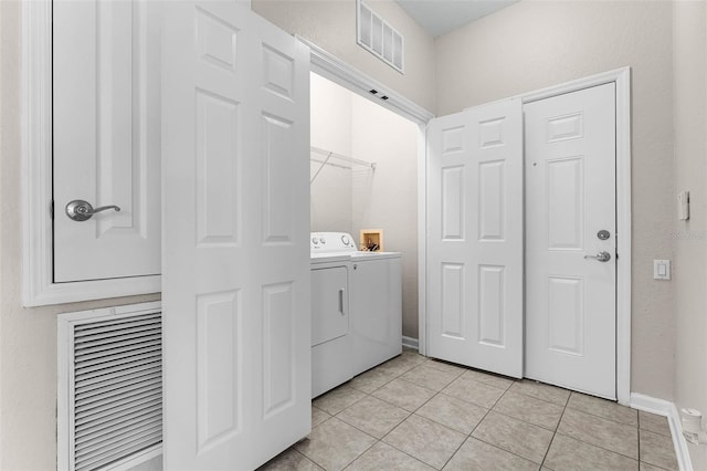 3314 Robert Trent Jones Dr Unit 308, Orlando, FL 32835 - washroom featuring visible vents, baseboards, laundry area, hookup for a washing machine, and light tile patterned flooring