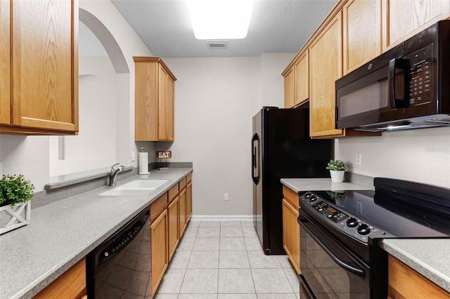 3314 Robert Trent Jones Dr Unit 308, Orlando, FL 32835 - kitchen featuring light tile patterned floors, light countertops, black appliances, visible vents, and a sink
