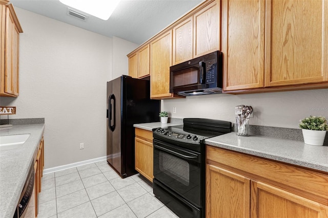 3314 Robert Trent Jones Dr Unit 308, Orlando, FL 32835 - kitchen with visible vents, baseboards, light countertops, black appliances, and light tile patterned flooring