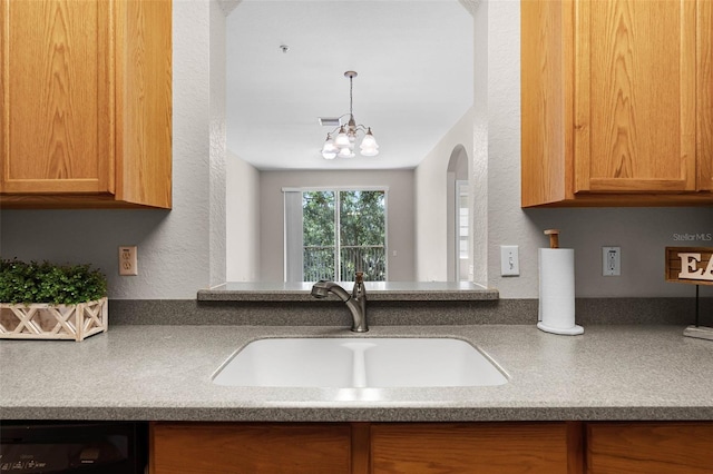 3314 Robert Trent Jones Dr Unit 308, Orlando, FL 32835 - kitchen with dishwashing machine, arched walkways, visible vents, a sink, and a textured wall