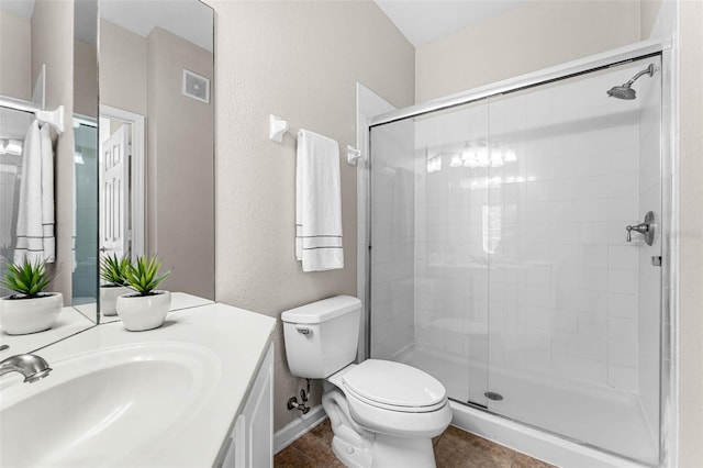 3314 Robert Trent Jones Dr Unit 308, Orlando, FL 32835 - full bathroom featuring a shower stall, vanity, visible vents, toilet, and tile patterned floors