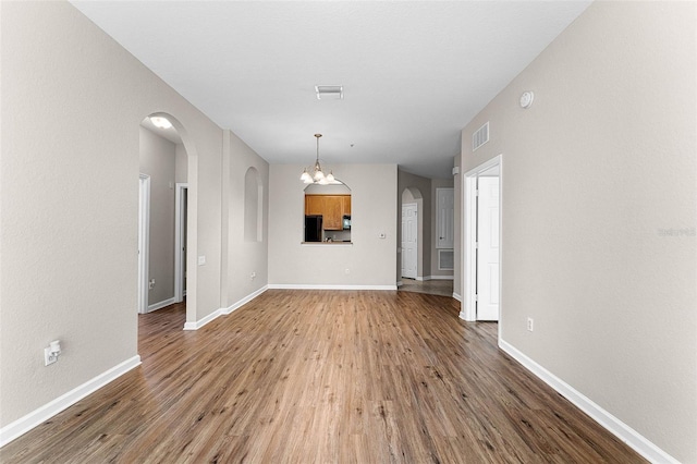 3314 Robert Trent Jones Dr Unit 308, Orlando, FL 32835 - interior space with visible vents, baseboards, arched walkways, and wood finished floors