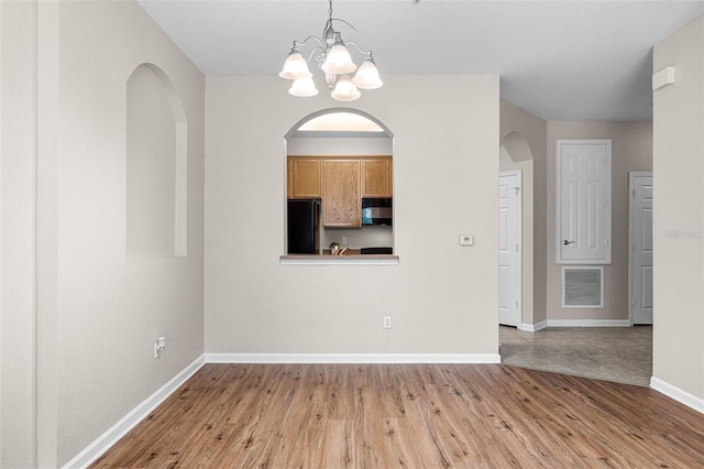 3314 Robert Trent Jones Dr Unit 308, Orlando, FL 32835 - interior space featuring visible vents, baseboards, an inviting chandelier, and wood finished floors