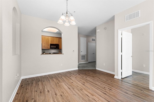 3314 Robert Trent Jones Dr Unit 308, Orlando, FL 32835 - interior space with a notable chandelier, visible vents, baseboards, and wood finished floors