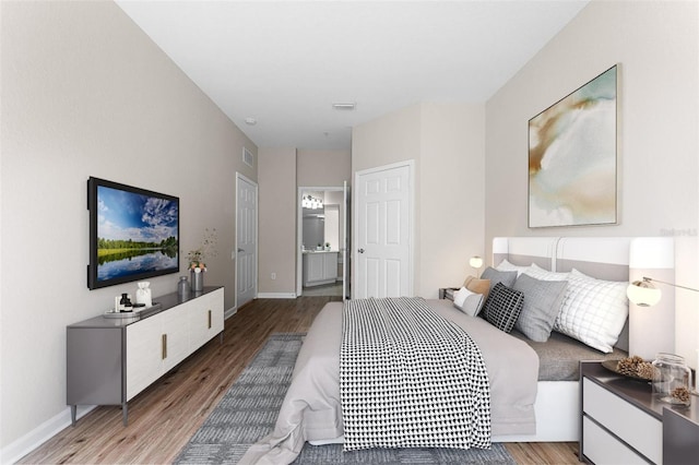 3314 Robert Trent Jones Dr Unit 308, Orlando, FL 32835 - bedroom featuring wood finished floors, baseboards, and visible vents