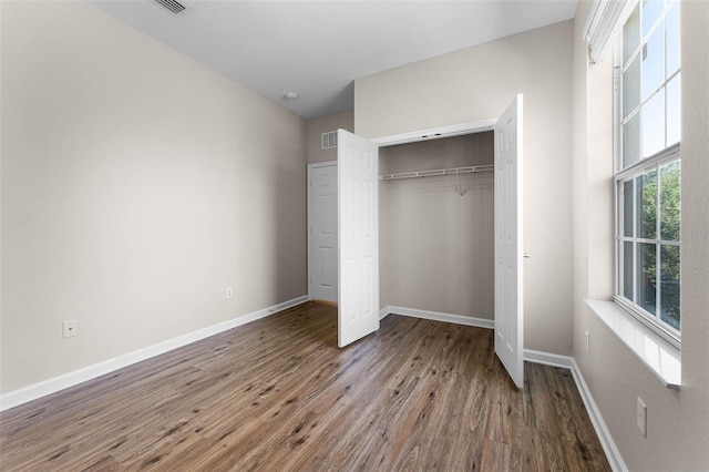 3314 Robert Trent Jones Dr Unit 308, Orlando, FL 32835 - unfurnished bedroom featuring visible vents, a closet, baseboards, and wood finished floors