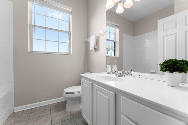 3314 Robert Trent Jones Dr Unit 308, Orlando, FL 32835 - full bathroom featuring baseboards, a notable chandelier, toilet, vanity, and tile patterned floors