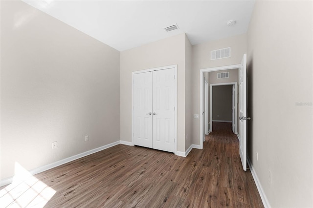 3314 Robert Trent Jones Dr Unit 308, Orlando, FL 32835 - unfurnished bedroom with visible vents, baseboards, and wood finished floors