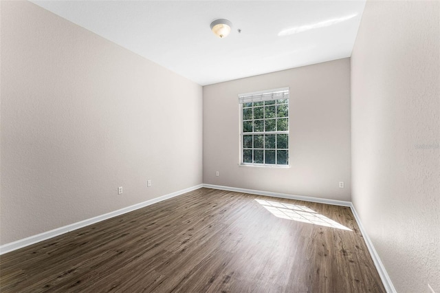 3314 Robert Trent Jones Dr Unit 308, Orlando, FL 32835 - unfurnished room with a textured wall, baseboards, and dark wood finished floors