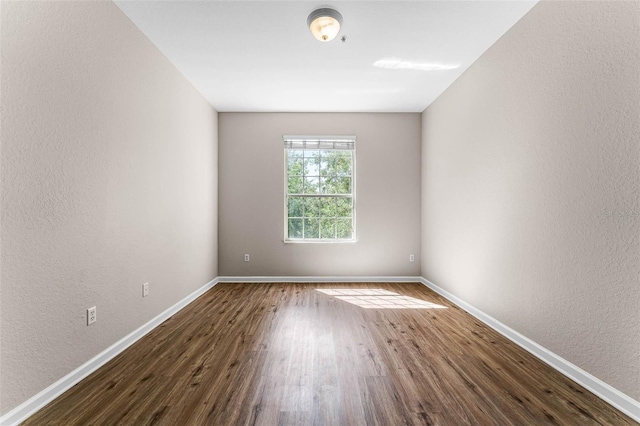 3314 Robert Trent Jones Dr Unit 308, Orlando, FL 32835 - spare room with dark wood-type flooring, baseboards, and a textured wall