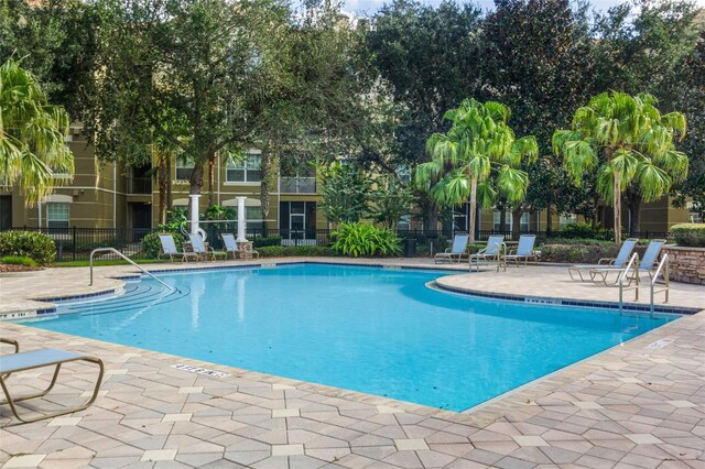 3314 Robert Trent Jones Dr Unit 308, Orlando, FL 32835 - community pool featuring a patio area and fence