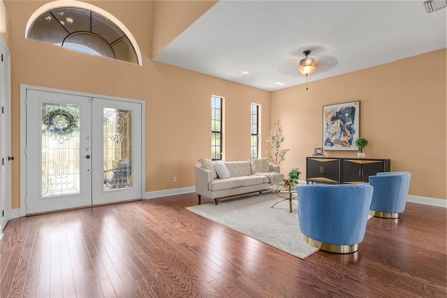 entrance foyer featuring wood finished floors, baseboards, visible vents, a ceiling fan, and french doors