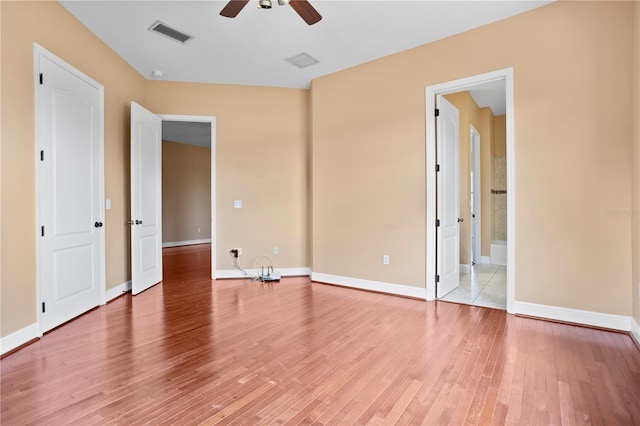 unfurnished bedroom featuring baseboards, visible vents, and light wood-style flooring