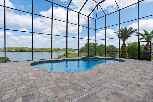 view of pool with a patio, a water view, and a pool with connected hot tub