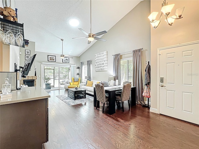419 Newton Pl, Longwood, FL 32779 - dining space with dark wood-type flooring, a textured ceiling, high vaulted ceiling, and ceiling fan with notable chandelier