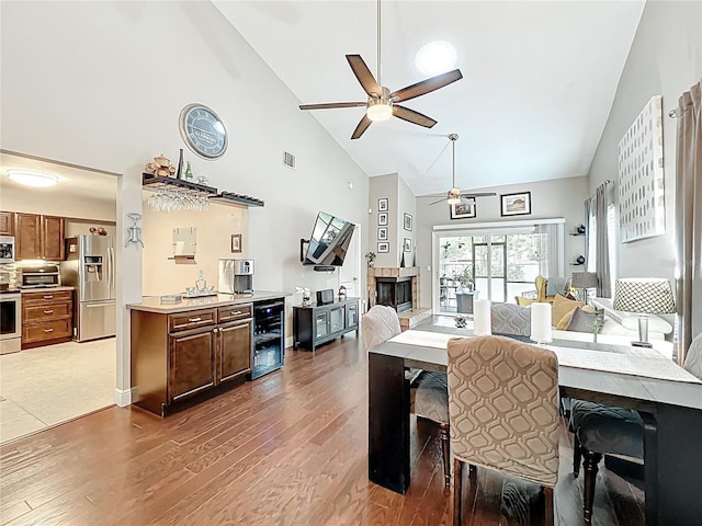 419 Newton Pl, Longwood, FL 32779 - dining room featuring visible vents, a fireplace, wood finished floors, a ceiling fan, and beverage cooler