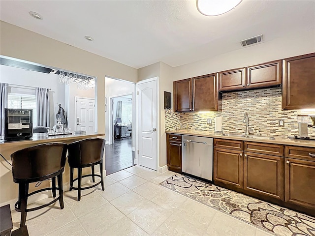 419 Newton Pl, Longwood, FL 32779 - kitchen with light countertops, backsplash, a sink, visible vents, and dishwasher