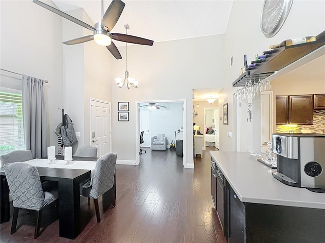 419 Newton Pl, Longwood, FL 32779 - dining area with dark wood-style flooring, a towering ceiling, ceiling fan with notable chandelier, and baseboards