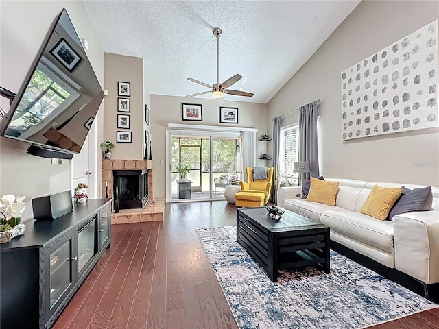 419 Newton Pl, Longwood, FL 32779 - living area with vaulted ceiling, a fireplace, a textured ceiling, ceiling fan, and dark wood-style flooring