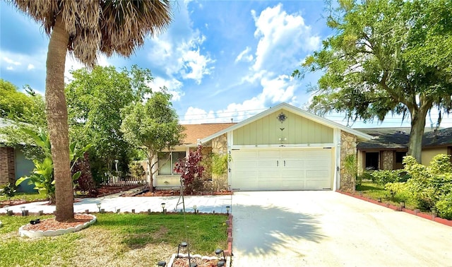 329 Kantor Blvd, Casselberry, FL 32707 - view of front of house featuring stone siding, driveway, an attached garage, and board and batten siding
