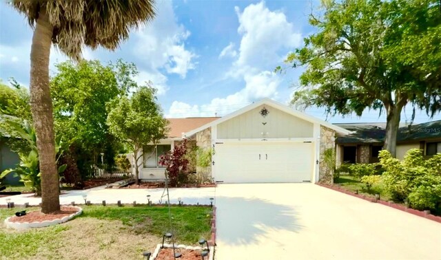 329 Kantor Blvd, Casselberry, FL 32707 - ranch-style house featuring concrete driveway, an attached garage, and stone siding