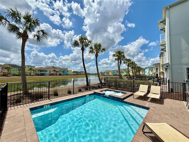 7968 Shaker St, Kissimmee, FL 34747 - view of pool featuring a residential view, a pool with connected hot tub, fence, and a water view