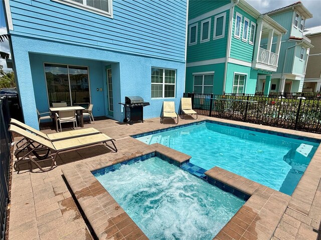7968 Shaker St, Kissimmee, FL 34747 - view of swimming pool with a patio, an in ground hot tub, grilling area, and fence