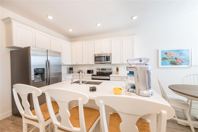 7968 Shaker St, Kissimmee, FL 34747 - kitchen with baseboards, a sink, light countertops, white cabinetry, and stainless steel appliances