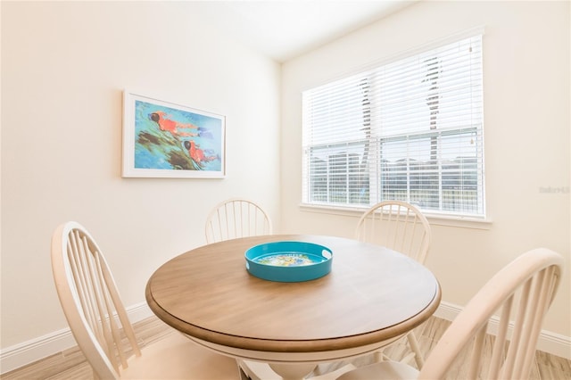 7968 Shaker St, Kissimmee, FL 34747 - dining area with light wood-style floors, baseboards, and a healthy amount of sunlight