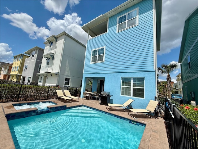 7968 Shaker St, Kissimmee, FL 34747 - back of house featuring a patio, a pool with connected hot tub, and fence