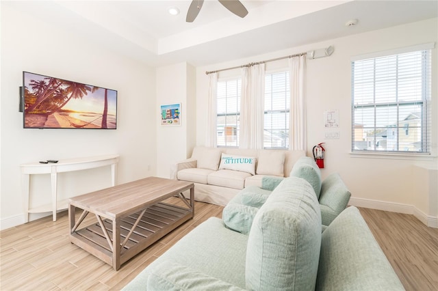 7968 Shaker St, Kissimmee, FL 34747 - living room featuring baseboards, recessed lighting, a ceiling fan, a tray ceiling, and light wood finished floors