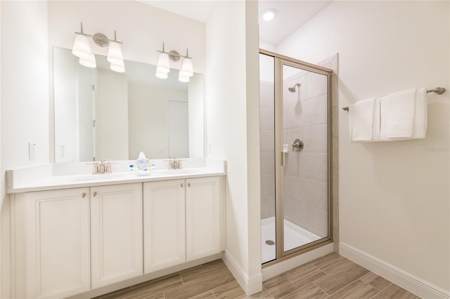 7968 Shaker St, Kissimmee, FL 34747 - bathroom featuring a shower stall, baseboards, a sink, and wood finish floors