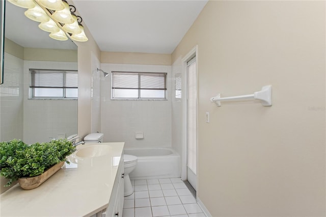 full bath featuring vanity, toilet, a chandelier, tile patterned floors, and washtub / shower combination