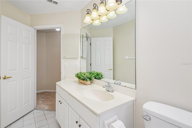 half bath with toilet, vanity, a chandelier, tile patterned flooring, and visible vents