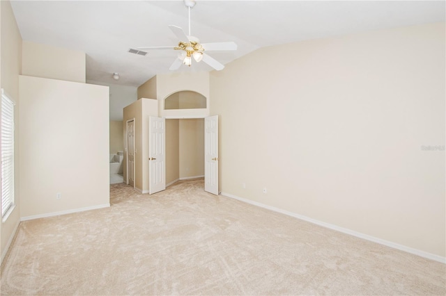 unfurnished bedroom with vaulted ceiling, baseboards, visible vents, a ceiling fan, and light carpet
