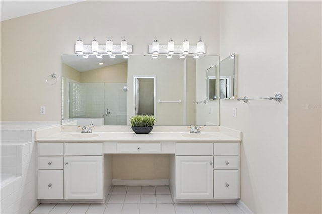 full bath featuring a bath, double vanity, and a sink