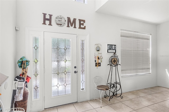 foyer entrance with light tile patterned floors