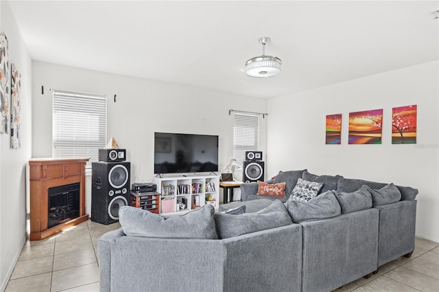 living area with light tile patterned flooring and a fireplace