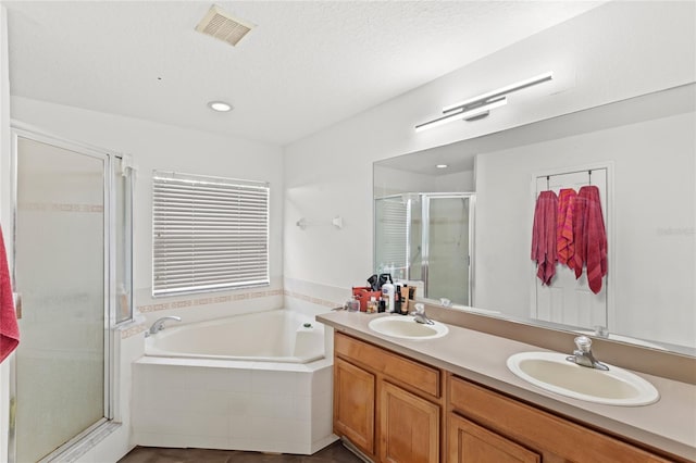 full bathroom with a sink, visible vents, a bath, and a shower stall