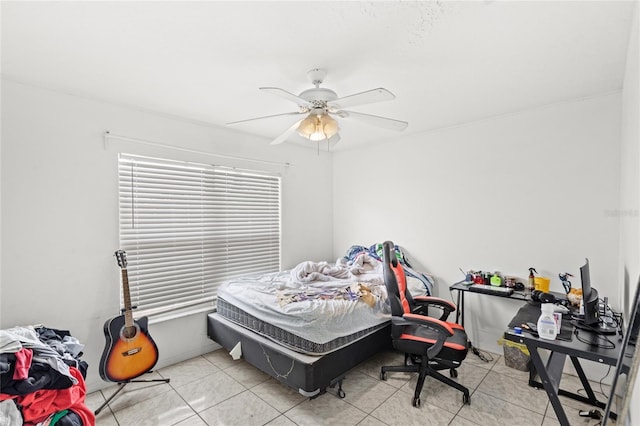 bedroom with ceiling fan and tile patterned flooring