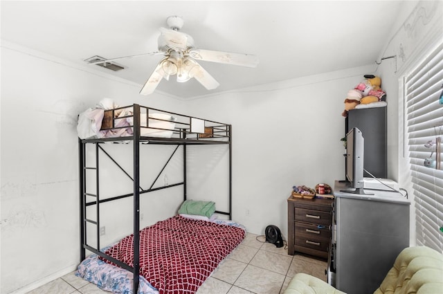 bedroom featuring ornamental molding, visible vents, tile patterned floors, and a ceiling fan
