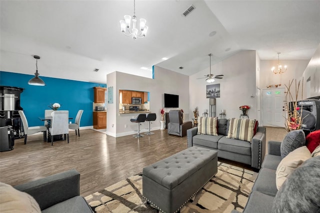 280 Bay St, Apopka, FL 32712 - living room featuring high vaulted ceiling, ceiling fan with notable chandelier, baseboards, visible vents, and wood finished floors