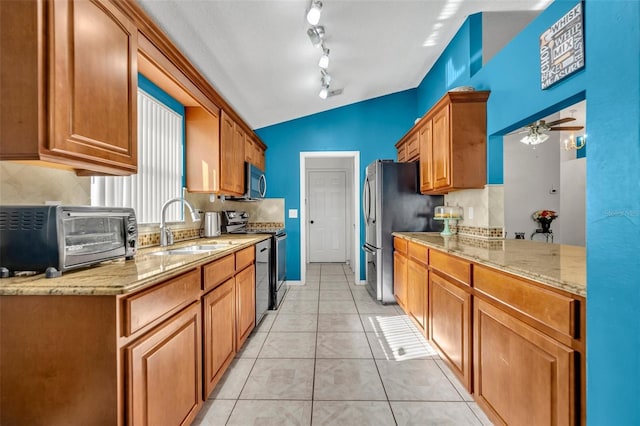 280 Bay St, Apopka, FL 32712 - kitchen featuring a toaster, stainless steel appliances, lofted ceiling, a sink, and light tile patterned floors