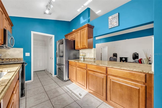 280 Bay St, Apopka, FL 32712 - kitchen with light tile patterned flooring, brown cabinets, light countertops, and stainless steel appliances