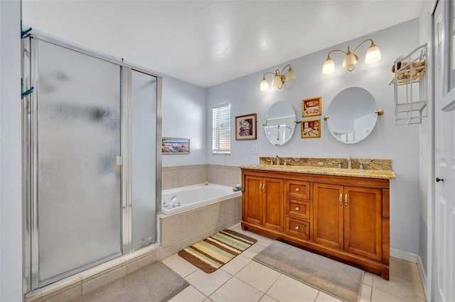 280 Bay St, Apopka, FL 32712 - bathroom with double vanity, a sink, a stall shower, a garden tub, and tile patterned flooring