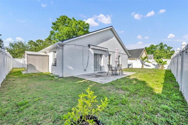 280 Bay St, Apopka, FL 32712 - back of house featuring a fenced backyard, stucco siding, a patio, and a yard