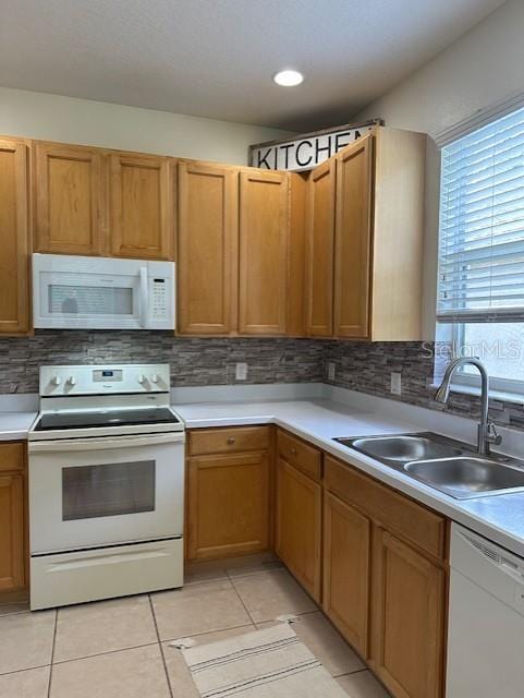 9723 Pecky Cypress Way, Orlando, FL 32836 - kitchen with white appliances, decorative backsplash, light countertops, and light tile patterned floors