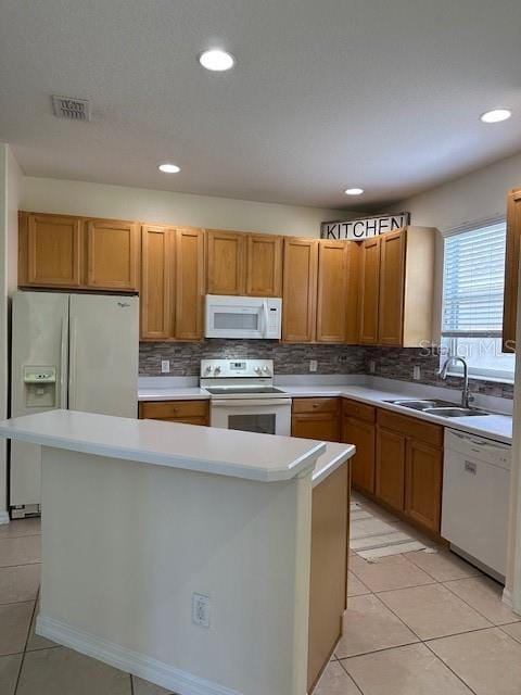 9723 Pecky Cypress Way, Orlando, FL 32836 - kitchen with white appliances, a center island, decorative backsplash, light tile patterned floors, and light countertops