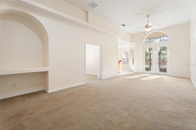 9723 Pecky Cypress Way, Orlando, FL 32836 - spare room with light colored carpet, french doors, and a ceiling fan