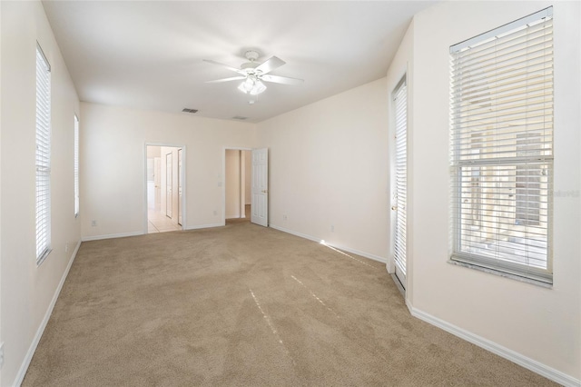 9723 Pecky Cypress Way, Orlando, FL 32836 - unfurnished bedroom with light carpet, multiple windows, and connected bathroom